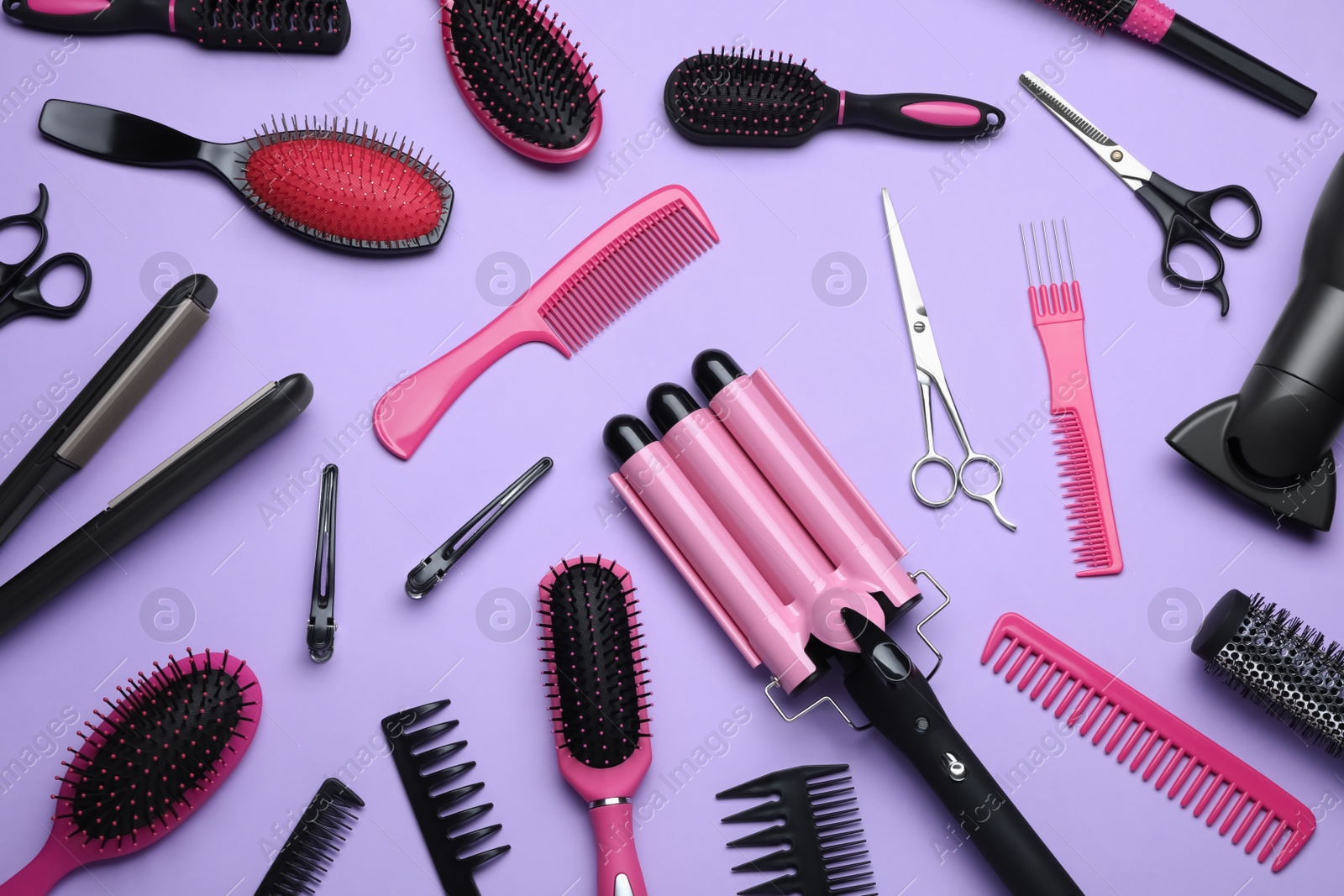 Photo of Flat lay composition of different professional hairdresser tools on lilac background