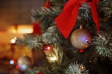 Photo of Christmas tree with beautiful decorations indoors, closeup. Stylish interior element