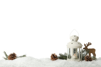 Beautiful composition with vintage Christmas lantern and festive decorations on snow against white background. Space for text