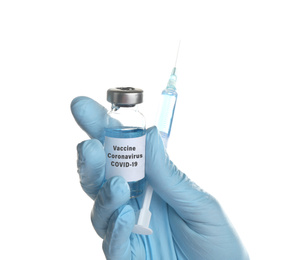 Doctor holding coronavirus vaccine and syringe on white background, closeup