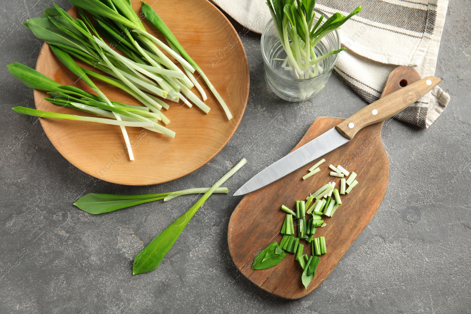 Photo of Flat lay composition with wild garlic or ramson on grey table