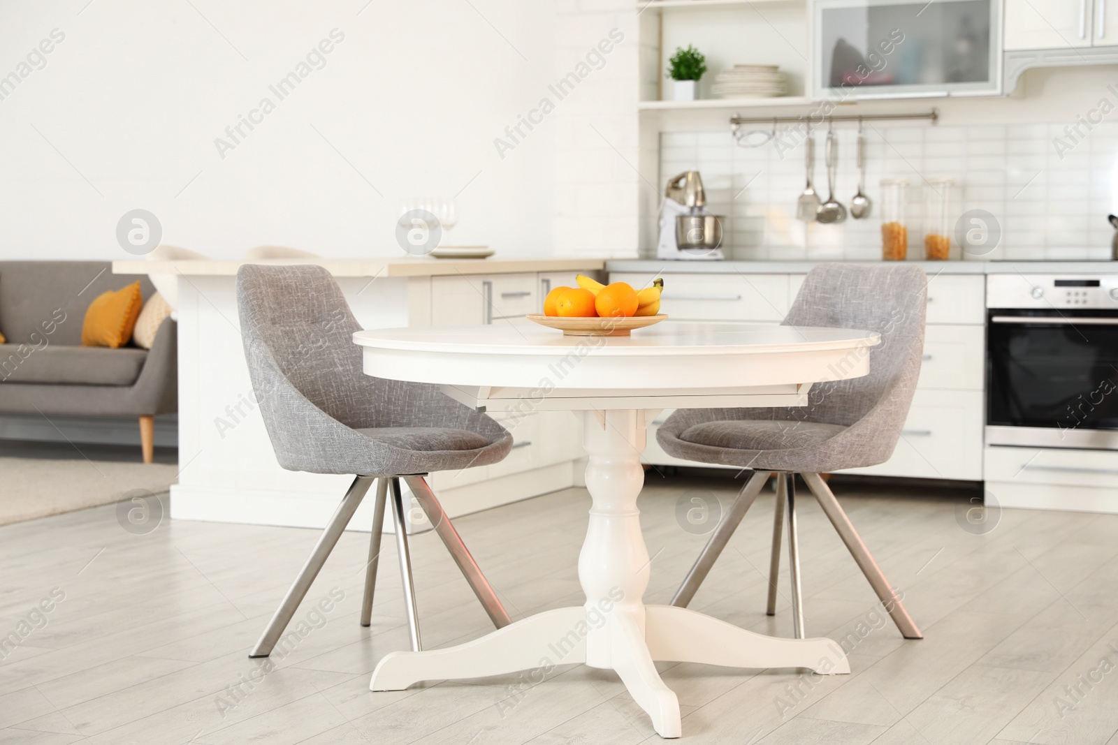 Photo of Stylish room interior with dining table and chairs