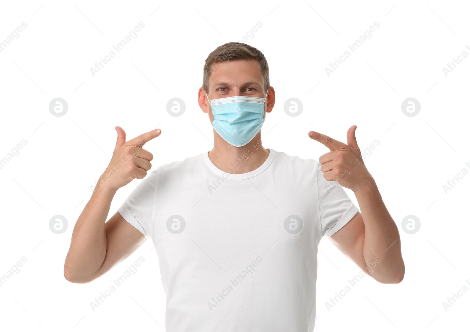 Photo of Male volunteer in mask on white background. Protective measures during coronavirus quarantine