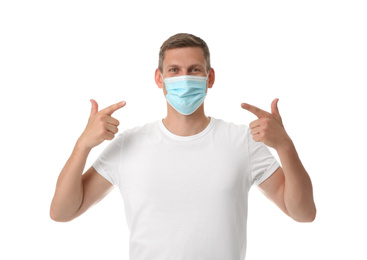 Photo of Male volunteer in mask on white background. Protective measures during coronavirus quarantine