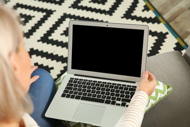 Photo of Woman using video chat on laptop at home, closeup. Space for text