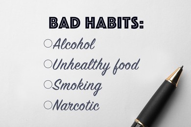 Image of List of bad habits and pen on white paper, top view. Change your lifestyle