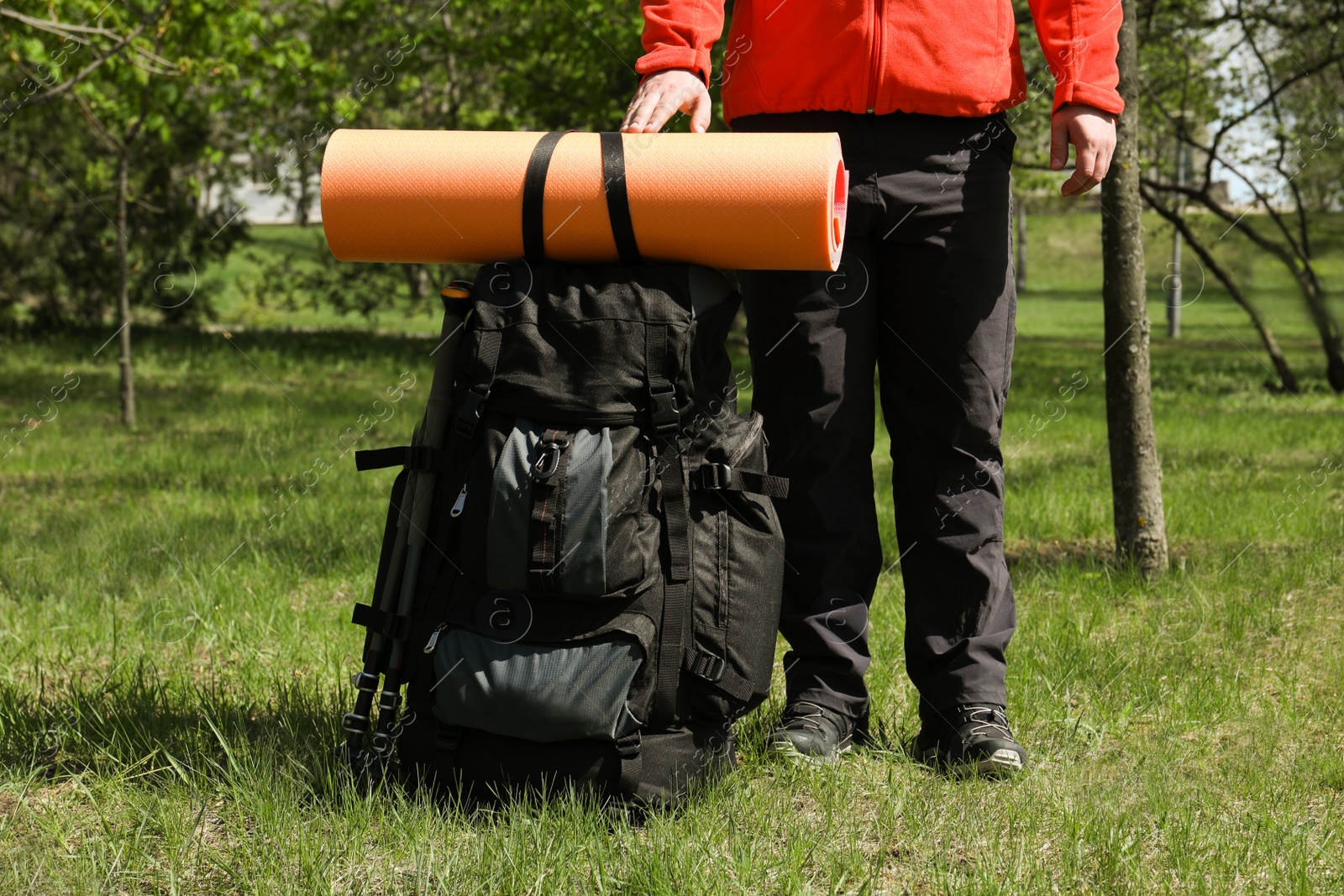 Photo of Hiker with backpack ready for journey in park, closeup