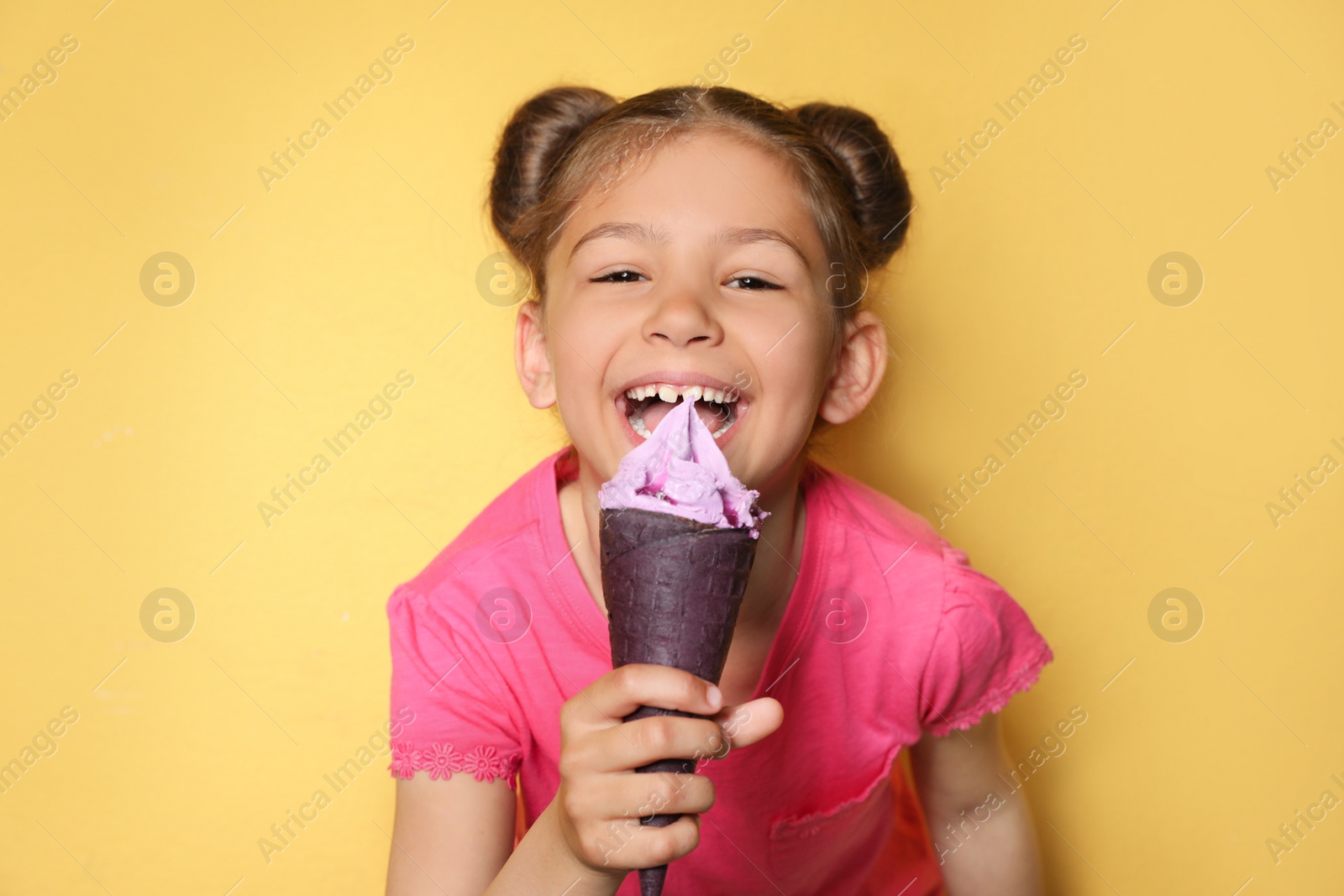 Photo of Adorable little girl with delicious ice cream against color background