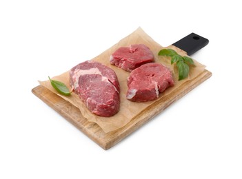 Photo of Fresh raw cut beef with basil leaves isolated on white