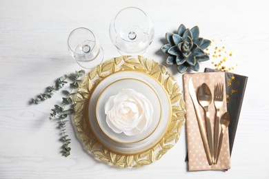 Elegant table setting on light background, top view