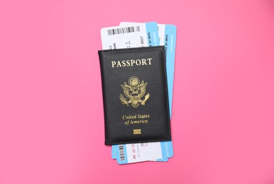 United States passport with tickets on pink background, top view