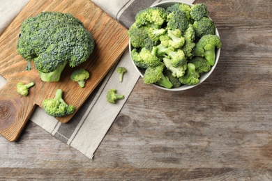 Photo of Flat lay composition with fresh green broccoli on wooden background