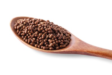 Wooden spoon with buckwheat tea granules on white background