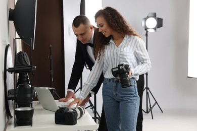 Handsome model with professional photographer in studio