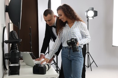 Photo of Handsome model with professional photographer in studio