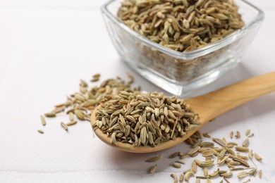 Photo of Bowl and spoon with fennel seeds on white table