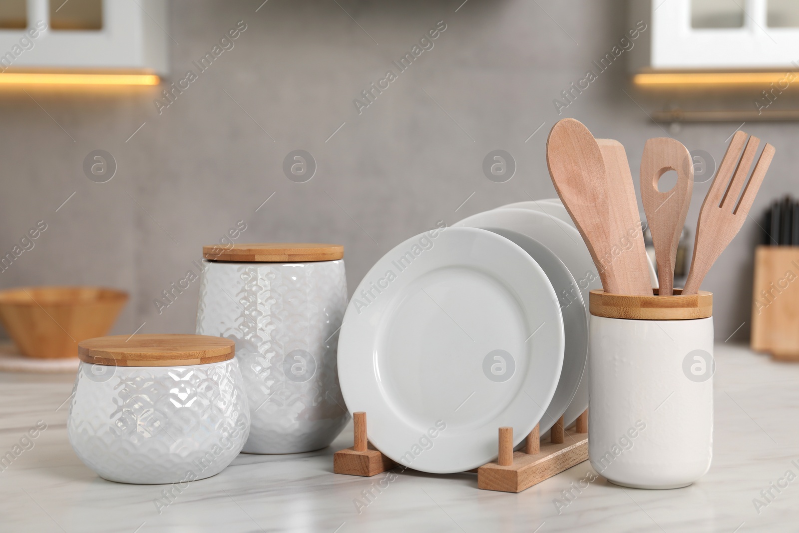 Photo of Set of different kitchenware on white table at home