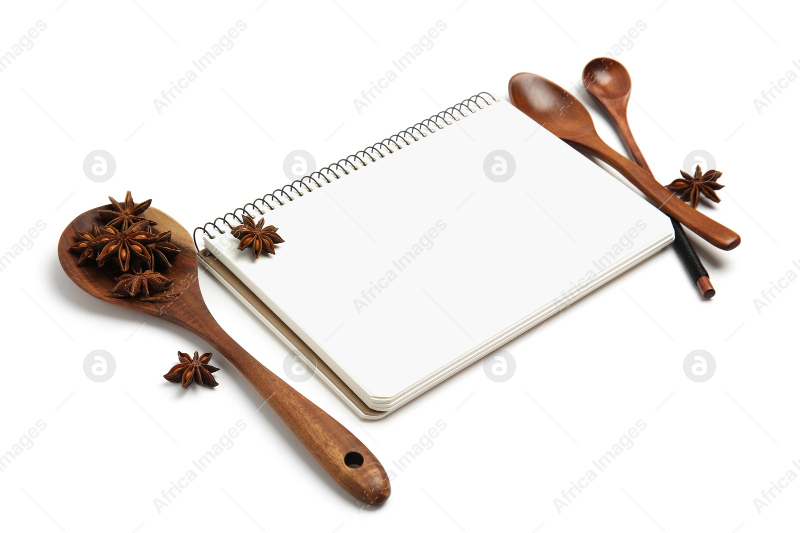 Photo of Blank recipe book, anise stars and wooden spoons on white background. Space for text