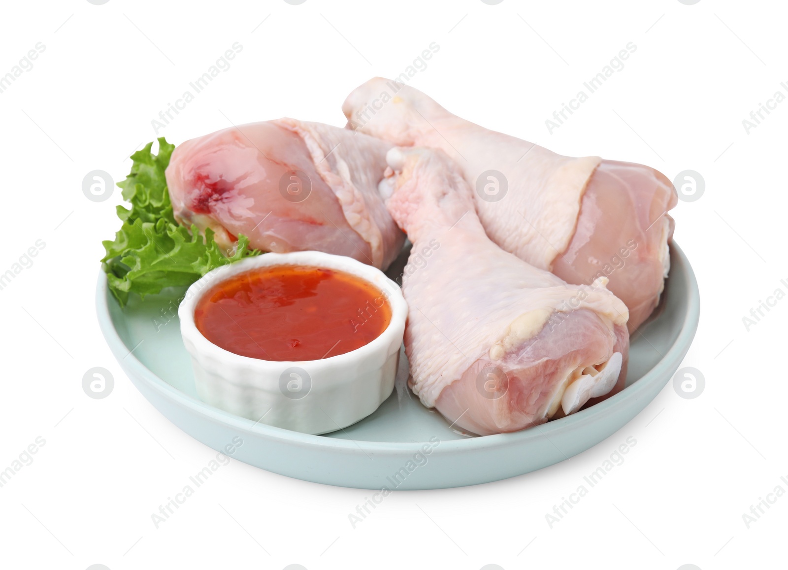 Photo of Fresh marinade, raw chicken drumsticks and lettuce isolated on white