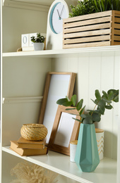 White shelving unit with different decorative elements