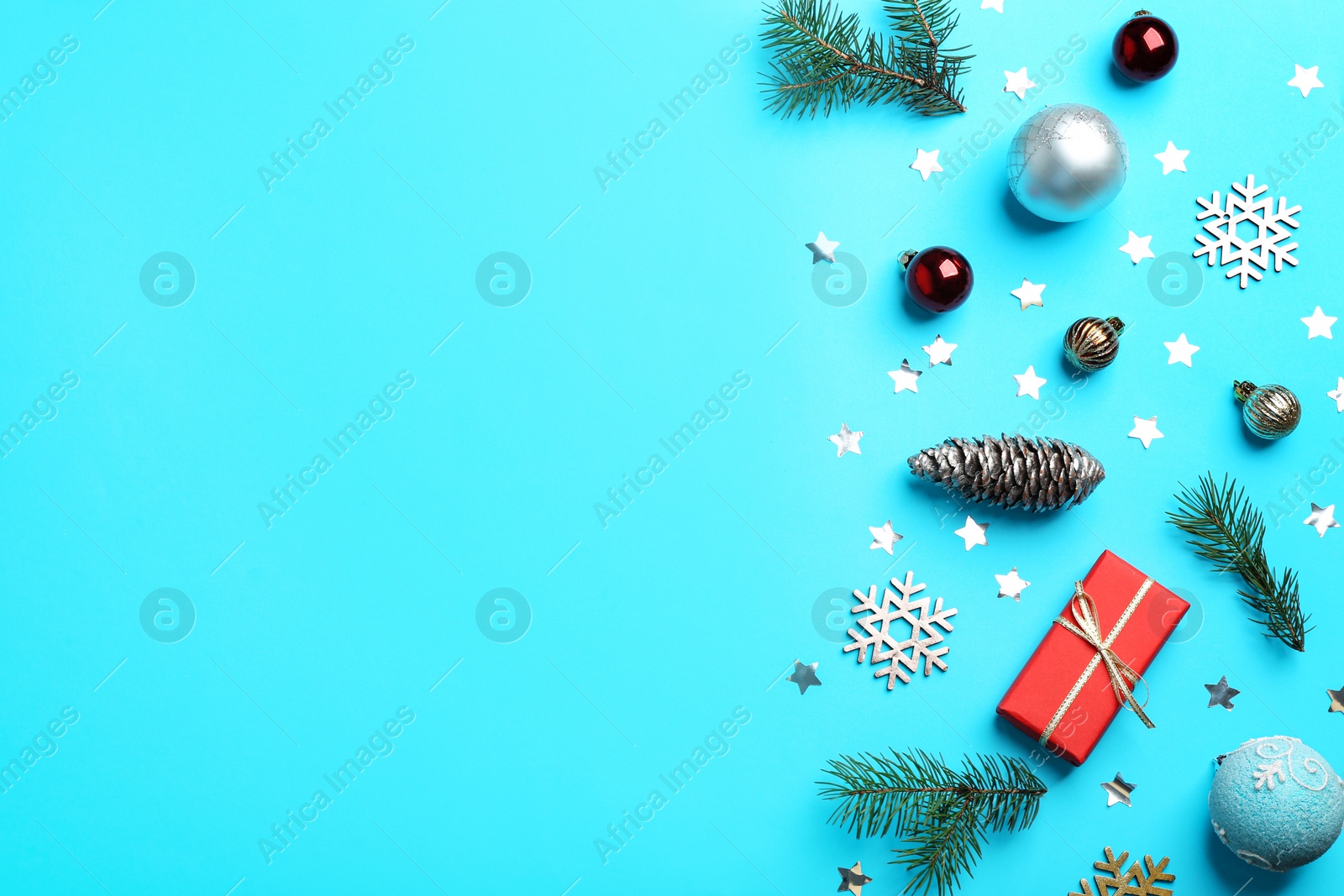 Photo of Flat lay composition with Christmas decor on light blue background. Space for text