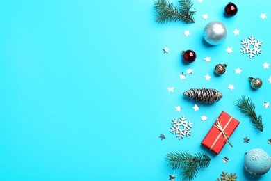 Photo of Flat lay composition with Christmas decor on light blue background. Space for text