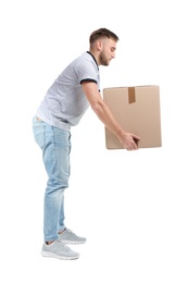 Photo of Full length portrait of young man lifting carton box on white background. Posture concept