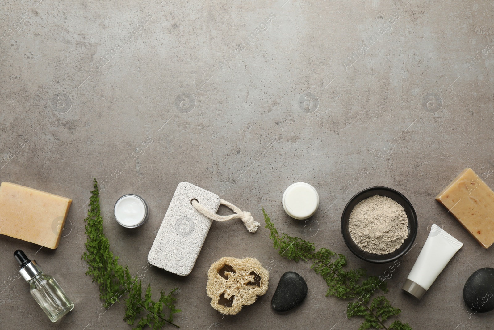 Photo of Flat lay composition with pumice stone on grey background. Space for text