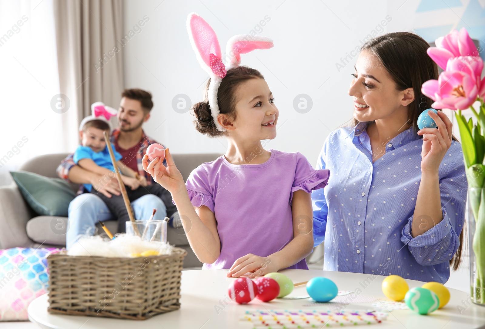 Photo of Happy family preparing for Easter holiday at home