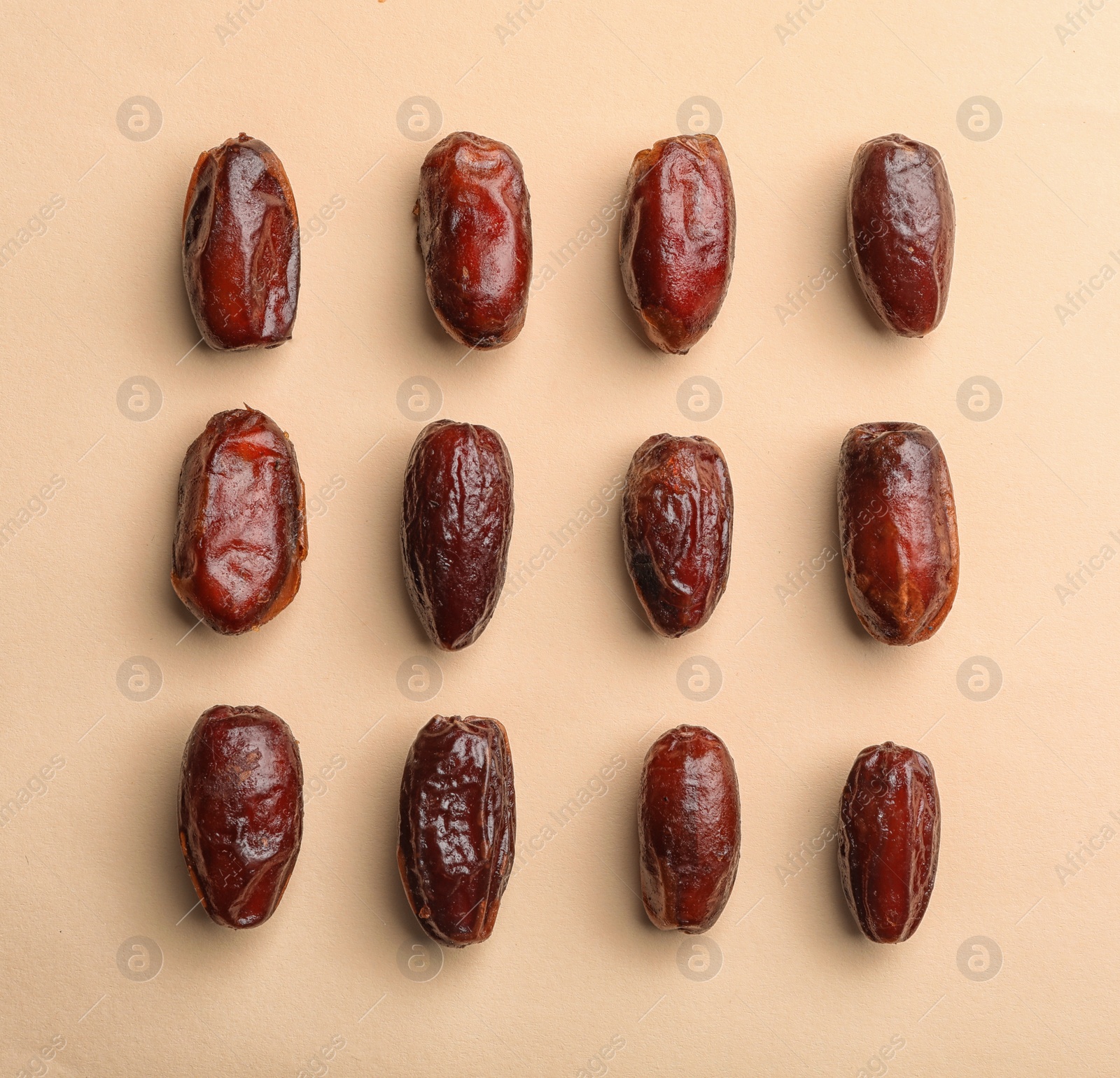 Photo of Sweet dried date fruits on color background, top view