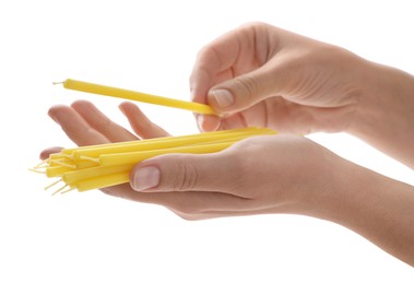 Woman holding church candles on white background, closeup