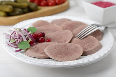 Tasty beef tongue pieces, berries and red onion on white wooden table, closeup