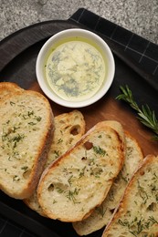 Tasty baguette with garlic and dill served on grey table, top view