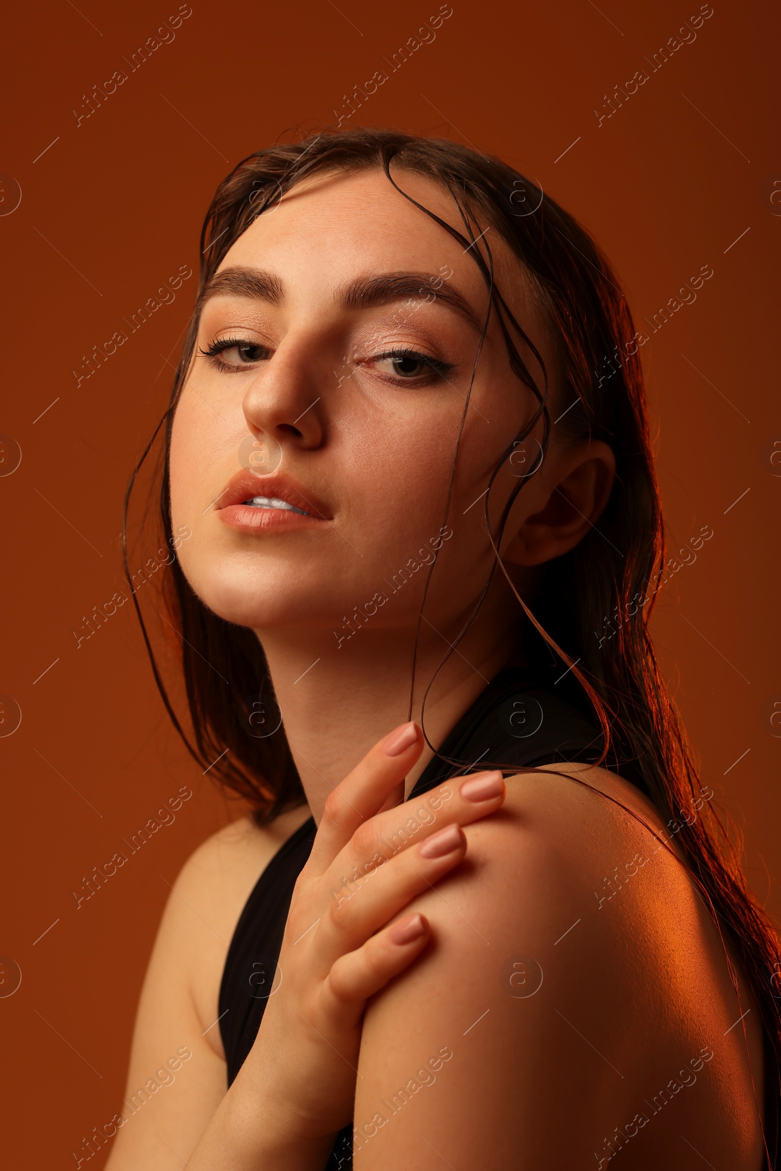 Photo of Portrait of beautiful woman on brown background