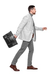 Photo of Handsome bearded businessman with briefcase on white background