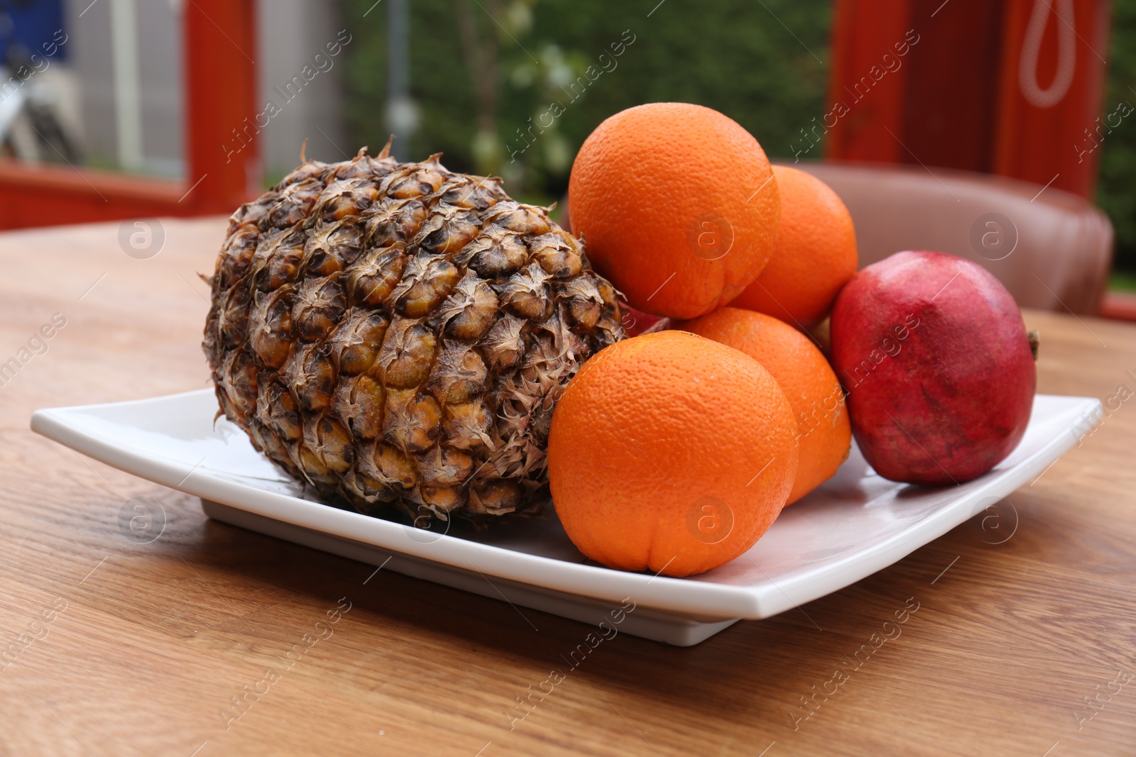 Photo of Delicious fresh fruits on wooden table indoors