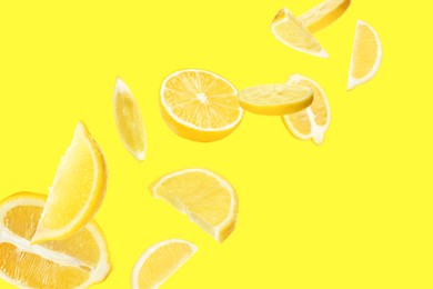Image of Fresh ripe lemons flying on yellow background