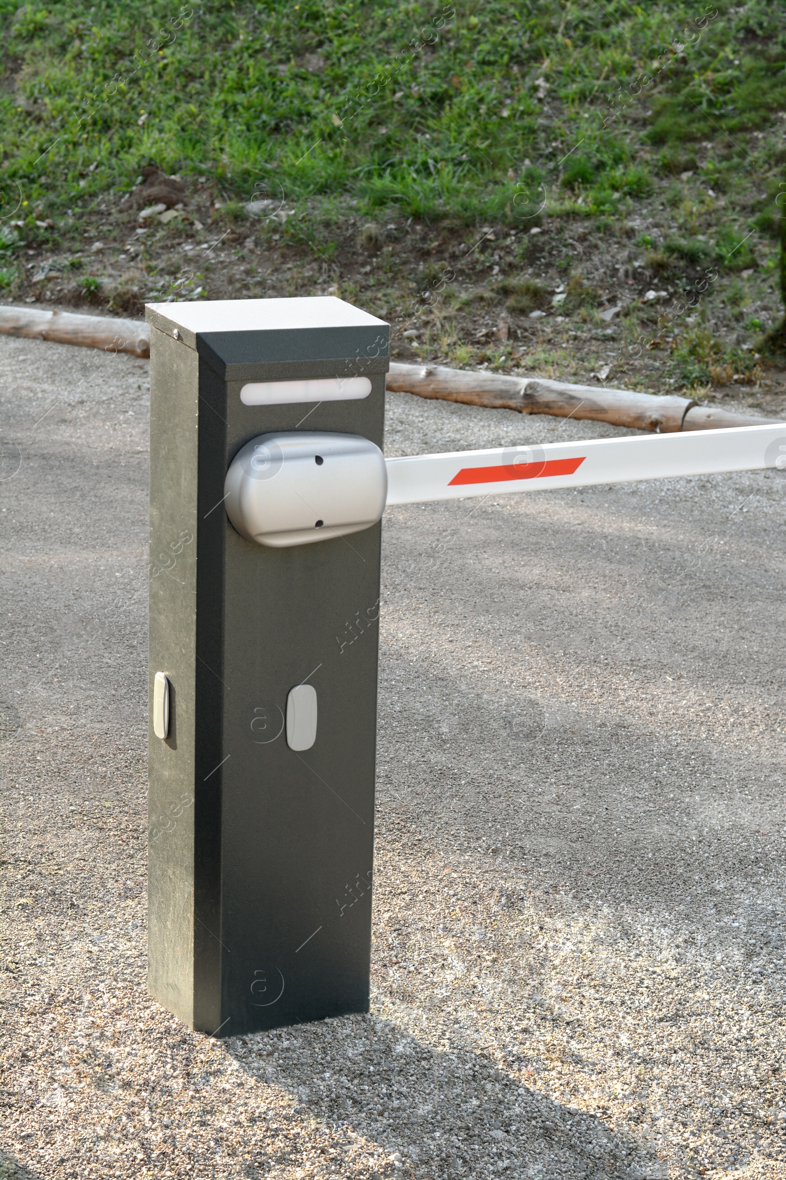 Photo of Closed boom barrier on sunny day outdoors