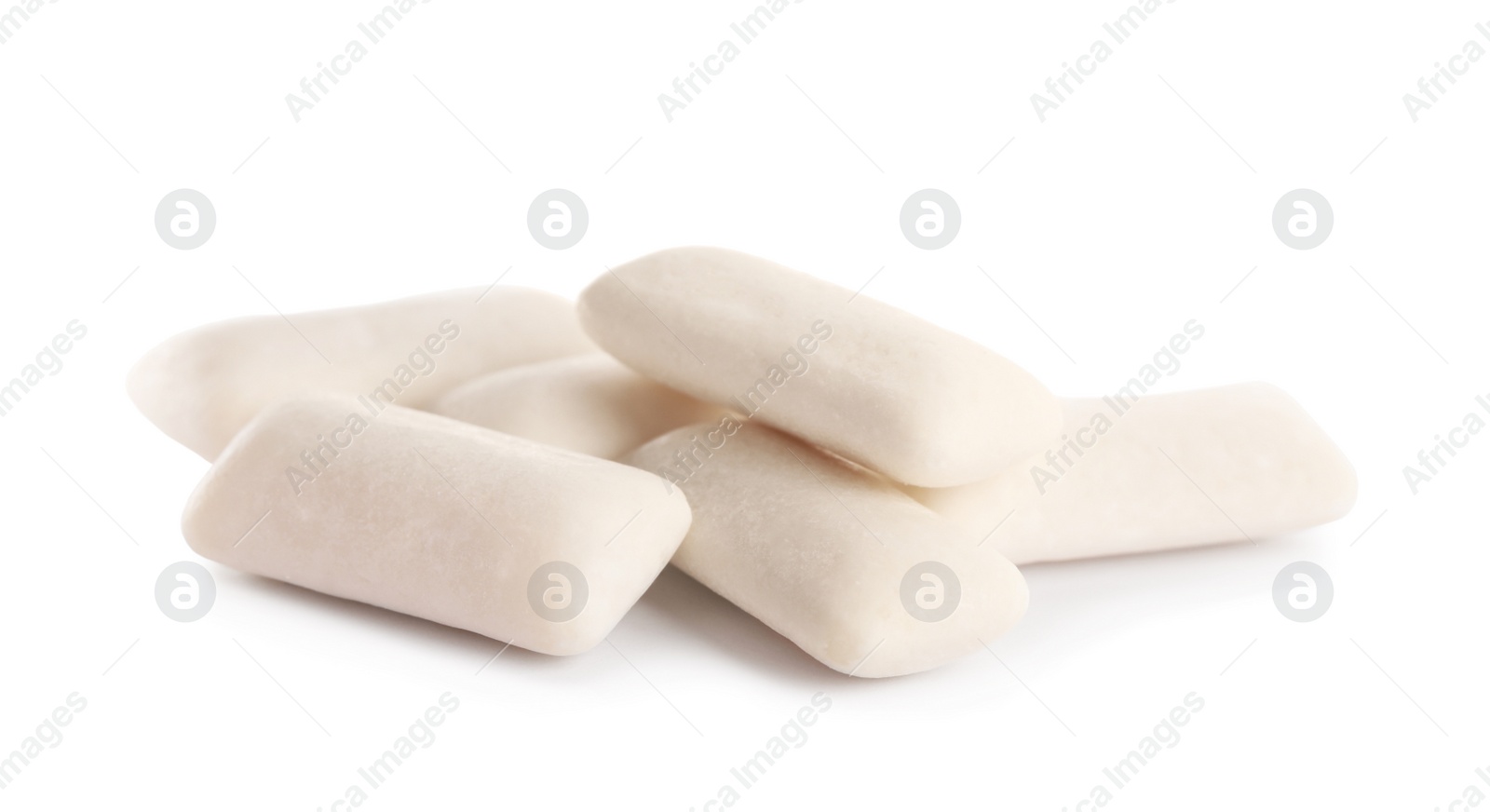 Photo of Heap of chewing gum pieces on white background