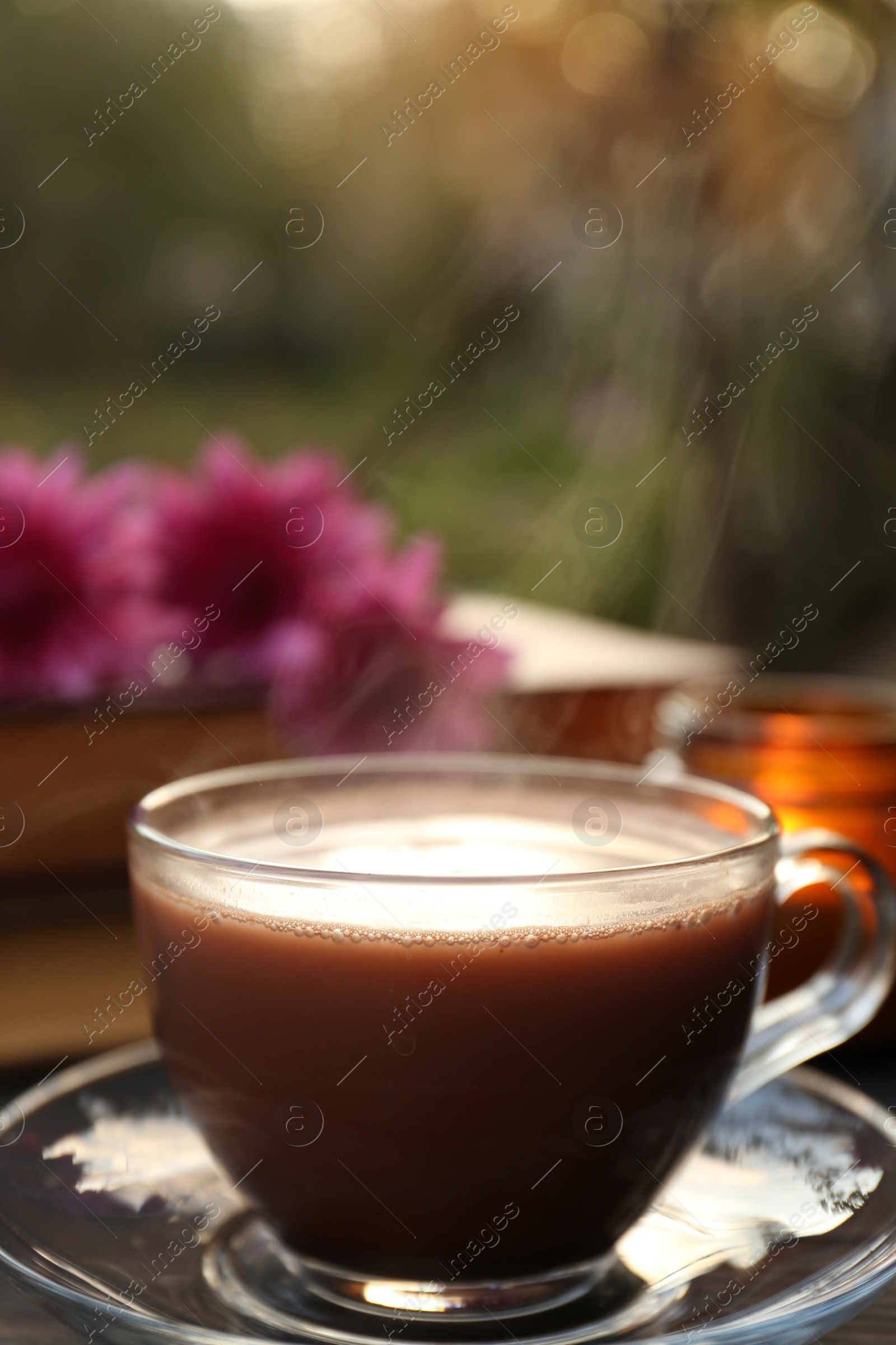 Photo of Glass cup with coffee on wooden table. Morning ritual
