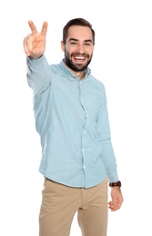 Young man celebrating victory on white background