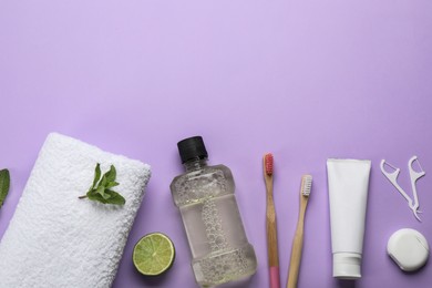 Flat lay composition with mouthwash and other oral hygiene products on violet background. Space for text