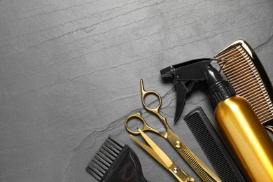 Photo of Hairdressing tools on grey textured background, flat lay. Space for text