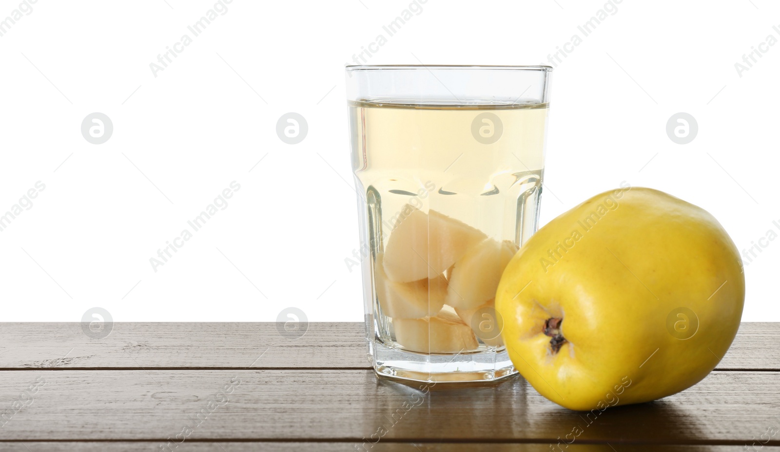 Photo of Delicious quince drink and fresh fruit on wooden table against white background