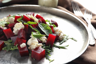 Photo of Plate with delicious beet salad on table, closeup