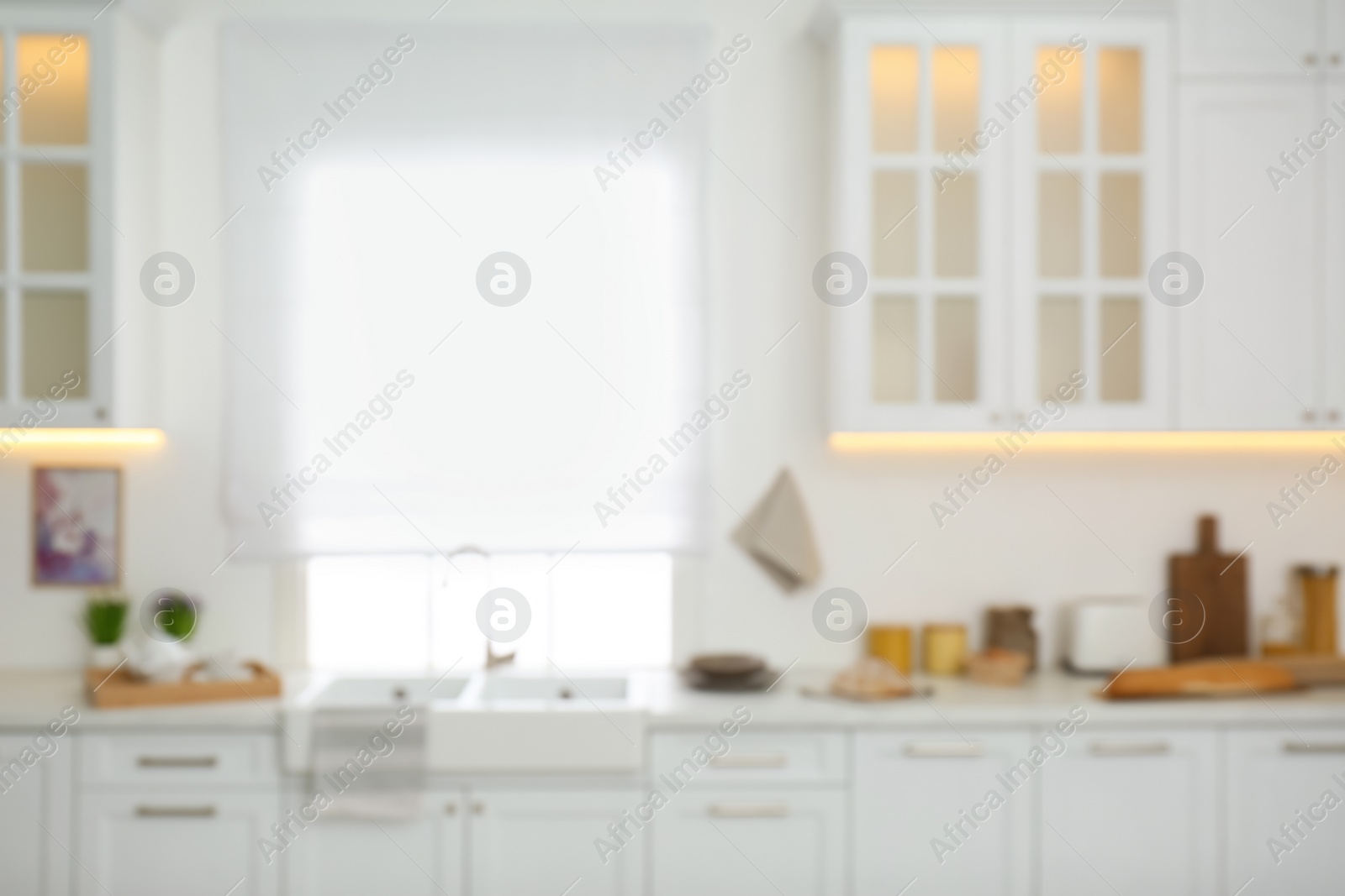 Photo of Blurred view of modern kitchen interior with stylish furniture