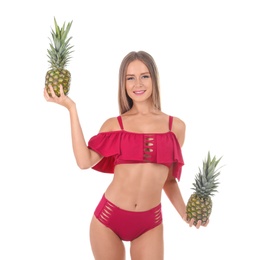 Photo of Sexy young woman in bikini with pineapples on white background