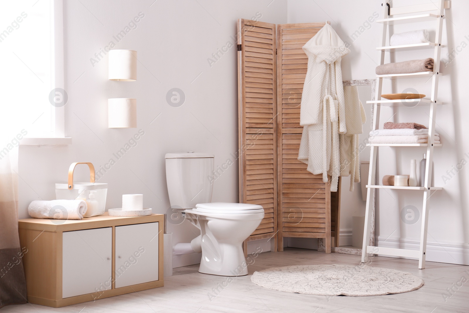 Photo of Ceramic toilet bowl in stylish bathroom. Idea for interior design