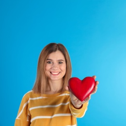 Photo of Portrait of woman with decorative heart on color background