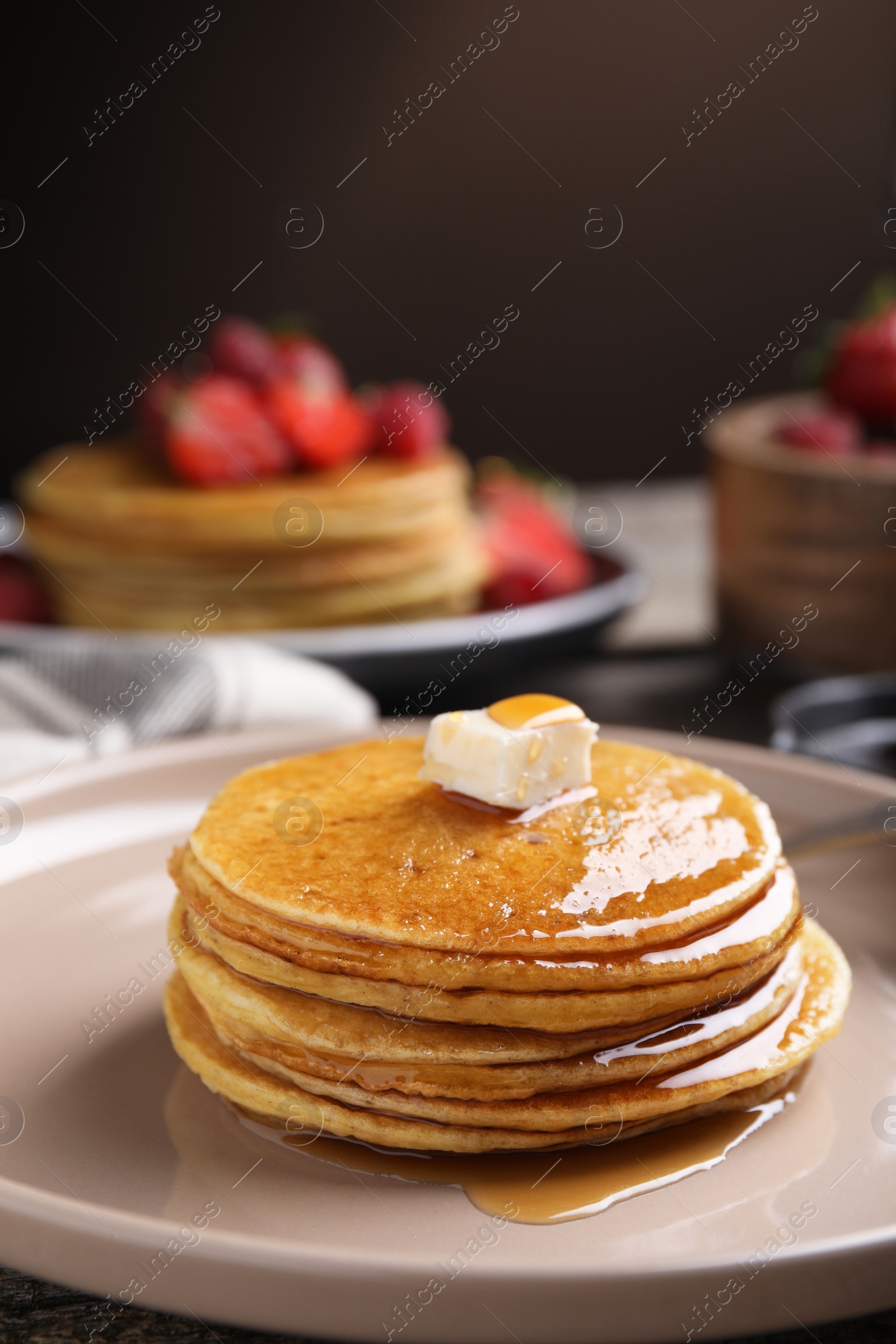 Photo of Tasty pancakes with butter and honey on plate, closeup